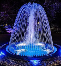 A stunning blue-lit dome fountain, constructed and designed by RES Group, enhancing outdoor spaces with brilliance