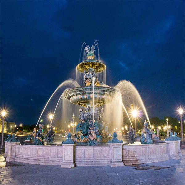 A majestic ornate fountain with illuminated water jets, constructed and designed by RES Group, enhancing public spaces with grandeur.