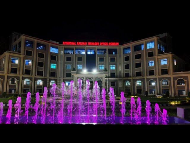 A vibrant fountain with purple jets, designed by RES Group for Howrah DRM New Office, enhancing the building's facade.