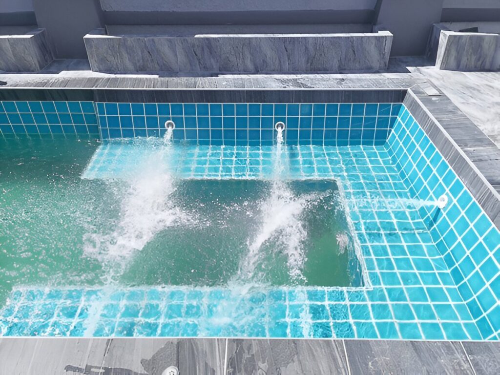 Swimming pool with elegant Deck Jets features, beautifully designed and installed by RESGROUP.