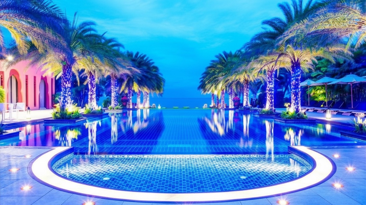 Modern underwater LED lighting installed in luxury infinity rooftop swimming pool at night